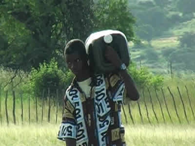 Man carrying water drum