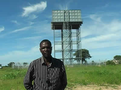 Man in front of water tower
